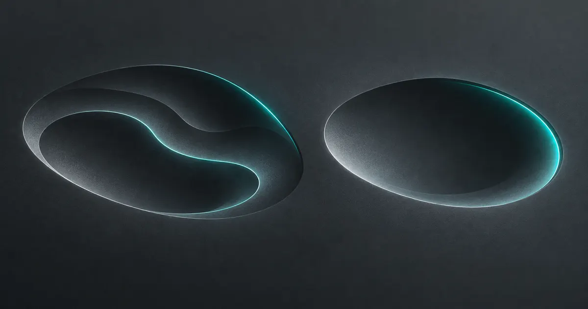 Two shallow depressions in a graphite surface, the right one smoother